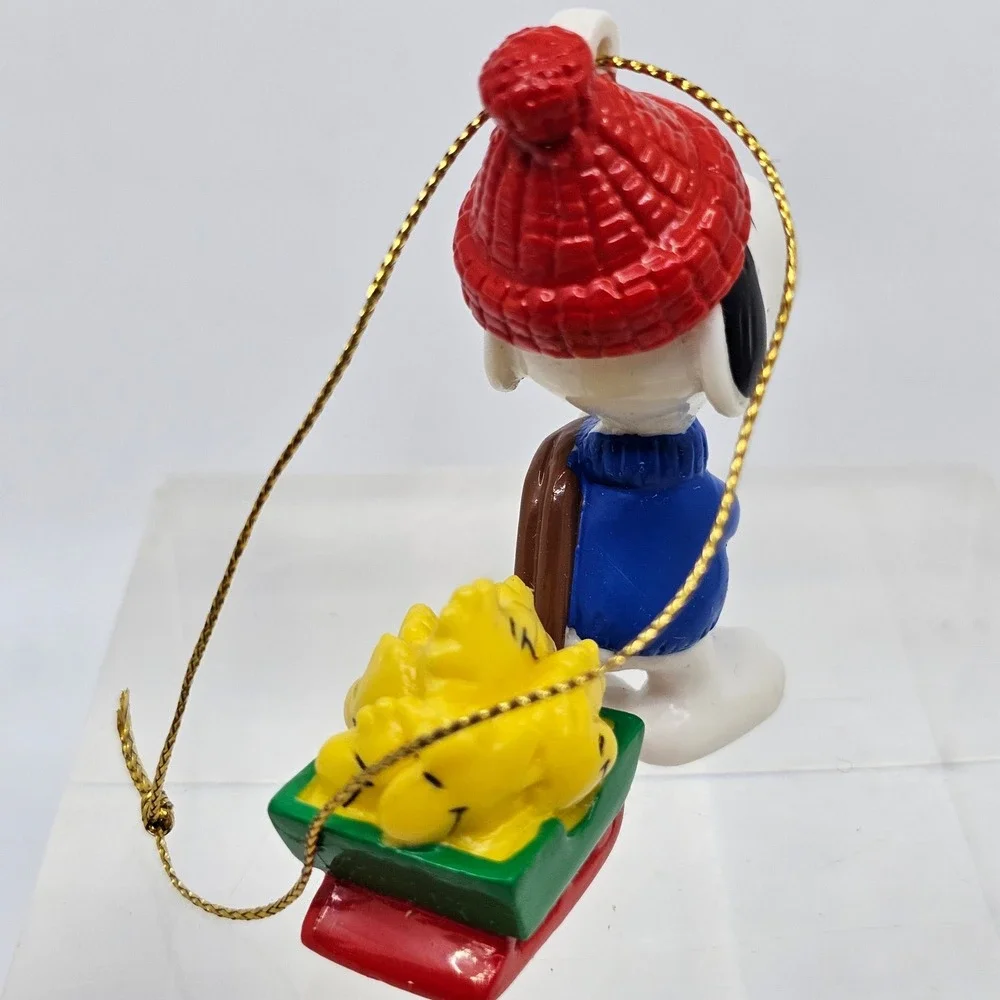 Snoopy Pulling Woodstocks Christmas Ornament. Peanuts. United Feature Syndicate